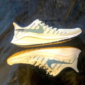 The brand is Nike and the main color is white and dark blue